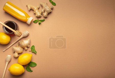 Photo for Orange detox drink, lemons, mint, ginger, honey in glass jar, honey wooden dippers top view. Food for immunity stimulation and against flu. Healthy remedies to boost immune system, copy space. - Royalty Free Image