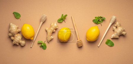 Photo for Composition with lemons, mint, ginger top view on simple beige background. Food for immunity stimulation and against seasonal flu. Healthy natural remedies to boost immune system. - Royalty Free Image