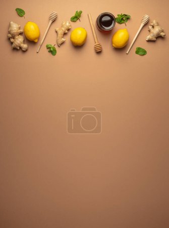 Photo for Composition with lemons, mint, ginger, honey in glass jar and honey wooden dippers top view. Food for immunity stimulation and against seasonal flu. Healthy natural remedies to boost immune system. - Royalty Free Image