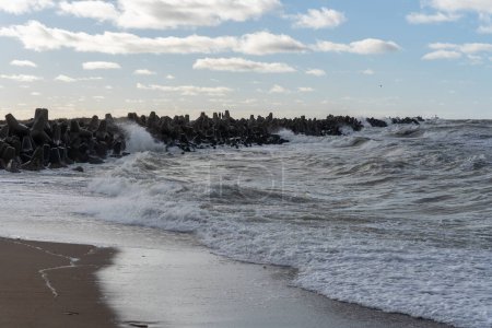 Photo for Waves crashing against breakwater consisting of gray concrete tetrapods. Liepaja, Latvia. Liepjas Ziemelu mols - Royalty Free Image