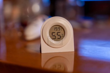 Photo for Electronic thermometer hygrometer measuring the optimal temperature and humidity in a room - Royalty Free Image