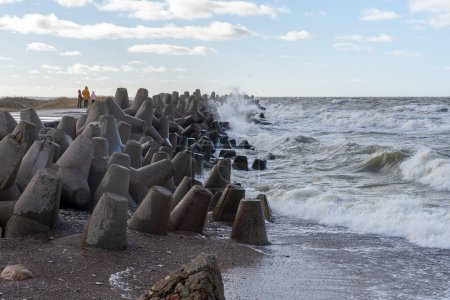Photo for Waves crashing against breakwater consisting of gray concrete tetrapods. Liepaja, Latvia. Liepajas Ziemelu mols - Royalty Free Image