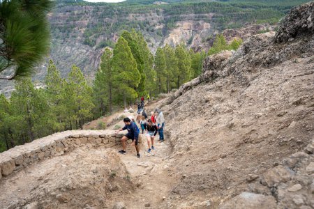 Photo for Gran Canaria, Spain - 05.12.2023: People hiking a trail to Roque Nublo volcanic rock on the island of Gran Canaria, Spain - Royalty Free Image