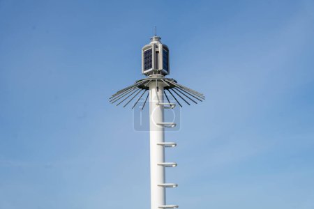 Breakwater light beacon with blue sky background