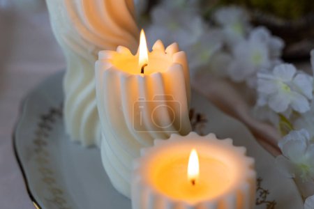 Lit spiral swirl pattern white soy wax candles