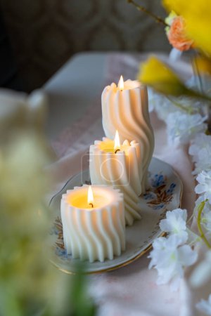 Lit spiral swirl pattern white soy wax candles