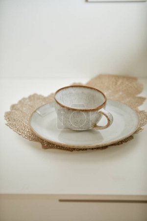 Rustic cup and saucer on lace doily