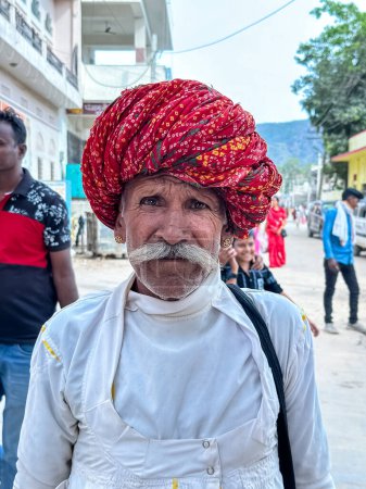 Photo for Pushkar, Rajasthan, India - November 2022: Portrait of rajasthani male with colorful turban on head during pushkar camel fair. - Royalty Free Image