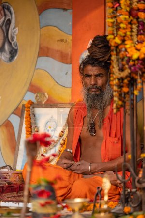 Photo for Varanasi, Uttar Pradesh, India - November 2022: Portrait of Unidentified Indian sadhu baba on ghat near river ganges in varanasi city at sunrise. - Royalty Free Image