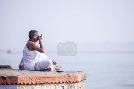 Photo for Varanasi, Uttar Pradesh, India - November 2022: Portrait of Unidentified Indian brahmin priest on ghat near river ganges in varanasi city. - Royalty Free Image