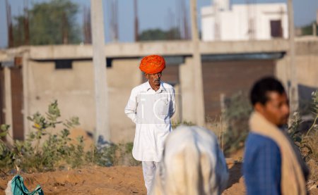 Photo for Pushkar, Rajasthan, India - November 2022: Pushkar Fair, camel trader in ethnic dress at fair ground during pushkar fair. - Royalty Free Image