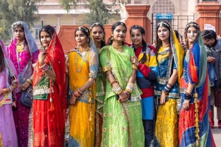 Foto de Bikaner, Rajasthan, India - January 2023: Camel Festival Bikaner, Group of young beautiful girls in traditional dress and jewellery of rajasthan while participating in the parade. Selective focus. - Imagen libre de derechos