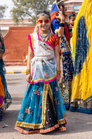 Photo for Bikaner, Rajasthan, India - January 2023: Portrait of an young beautiful girl from kashmir in traditional dress smiling while participating in bikaner camel festival parade. - Royalty Free Image