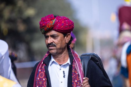 Foto de Bikaner, Rajasthan, India - January 2023: Camel Festival, Portrait of an young male wearing turban. Rajput male of bikaner. - Imagen libre de derechos