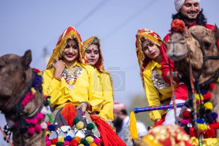 Photo for Bikaner, Rajasthan, India - January 2023: Portrait of an young beautiful woman from kashmir in traditional dress smiling while participating in bikaner camel festival parade. - Royalty Free Image