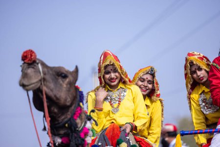 Photo for Bikaner, Rajasthan, India - January 2023: Portrait of an young beautiful woman from kashmir in traditional dress smiling while participating in bikaner camel festival parade. - Royalty Free Image