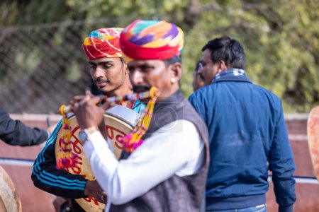 Photo for Bikaner, Rajasthan, India - January 2023: Camel Festival, Portrait of an rajasthani male with moustache, colorful turban wearing traditional colorful rajasthani dress. Rajput male of bikaner. - Royalty Free Image