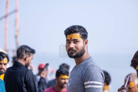 Photo for Varanasi, Uttar Pradesh, India - November 2022: Portrait of Unidentified Indian male standing with tilak his forehead on ghats near river ganges in varanasi city. - Royalty Free Image