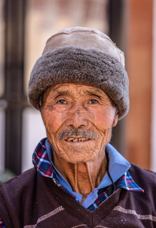 Photo for Sarnath, Uttar Pradesh, India - November 2022: Portrait of an old man from tibbet with smiling face. - Royalty Free Image