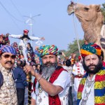 Bikaner, Rajasthan, India - January 13 2023: Camel Festival, Portrait of an young rajasthani male with beard and moustache wearing white traditional rajasthani dress and turban.