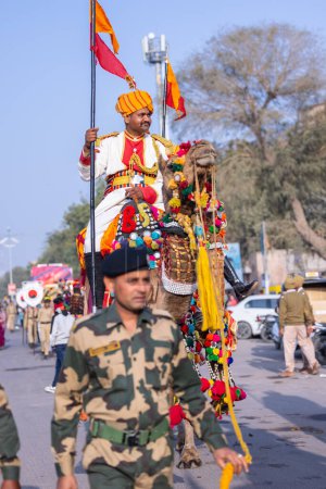 Photo for Bikaner, Rajasthan, India - January 13 2023: Camel festival, Soldier of Indian army participating in camel festival of bikaner parade on camels. Decorated camels participating in camel festival. - Royalty Free Image