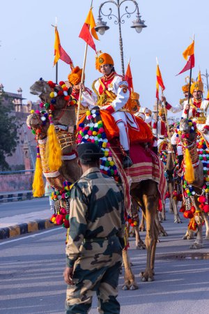 Photo for Bikaner, Rajasthan, India - Jan 13 2023: Camel festival, Female soldier of Indian army participating in camel festival of bikaner parade on camels. Decorated camels participating in camel festival. - Royalty Free Image