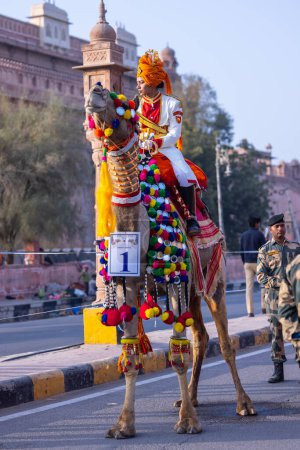 Photo for Bikaner, Rajasthan, India - Jan 13 2023: Camel festival, Female soldier of Indian army participating in camel festival of bikaner parade on camels. Decorated camels participating in camel festival. - Royalty Free Image