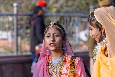 Photo for Bikaner, Rajasthan, India - January 13 2023: Camel Festival Bikaner, Group of young beautiful girls in traditional rajasthani dress and jewellery while participating in the parade. Selective focus. - Royalty Free Image