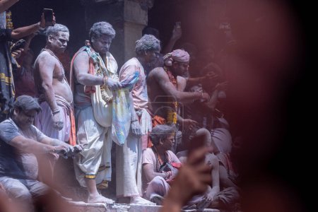 Photo for Varanasi, Uttar Pradesh, India - March 04 2023: Masan Holi, Group of unidentified people celebrating the festival of holi at manikarnika ghat with rituals. Manikarnika ghat is a cremation point - Royalty Free Image