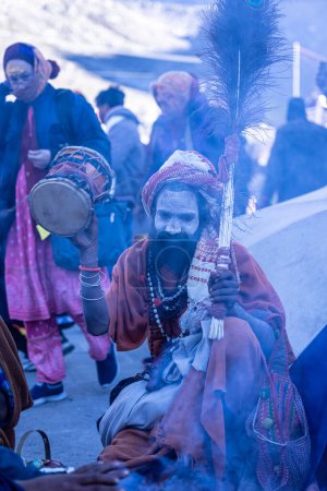 Photo for Kedarnath, Uttarakhand, India - October 15 2022: Portrait of an old naga sadhu baba in traditional dress and ashes on face outside the holy temple of baba kedarnath. - Royalty Free Image