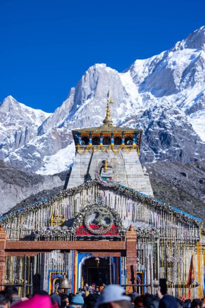 Photo for Kedarnath, Uttarakhand, India - October 14 2022: Baba kedarnath temple with snow covered himalayan mountains in background. Kedarnath temple is one of the lord shiva jyotirlinga and sacred place - Royalty Free Image