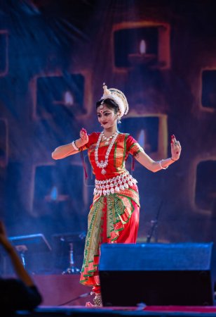 Photo for Pushkar, Rajasthan, India - November 05 2022: Female artist performing classical dance Odissi in traditional colorful ethnic dress and jewellery during Pushkar fair - Royalty Free Image