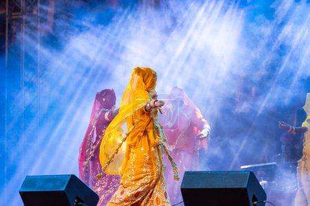 Photo for Pushkar, Rajasthan, India - November 05, 2022: Portrait of female artists performing rajasthani folk dance Ghoomar with veils in traditional colorful dresses in Pushkar fair - Royalty Free Image