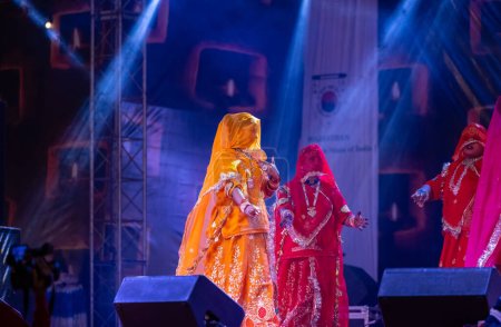 Photo for Pushkar, Rajasthan, India - November 05, 2022: Portrait of female artists performing rajasthani folk dance Ghoomar with veils in traditional colorful dresses in Pushkar fair - Royalty Free Image