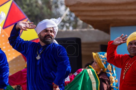 Photo for Faridabad, Haryana, India - February 04 2023: Portrait of male artist from haryana while performing the folk dance in ethnic dresses at surajkund craft fair - Royalty Free Image