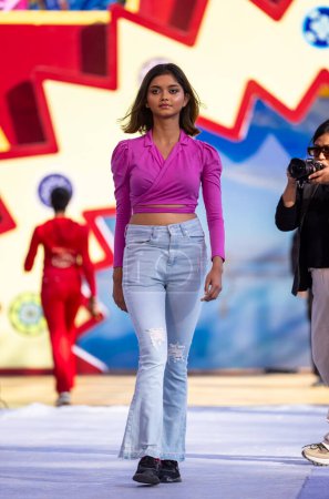 Photo for Faridabad, Haryana, India - February 04, 2023: Portrait of beautiful young girl performing ramp walk in modern clothes during fashion show at surajkund craft fair - Royalty Free Image