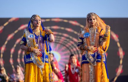 Photo for Bikaner, Rajasthan, India - January 14, 2023: Portrait of young beautiful indian women in ethnic rajasthani dresses participating in miss marwar fashion show during bikaner camel festival - Royalty Free Image