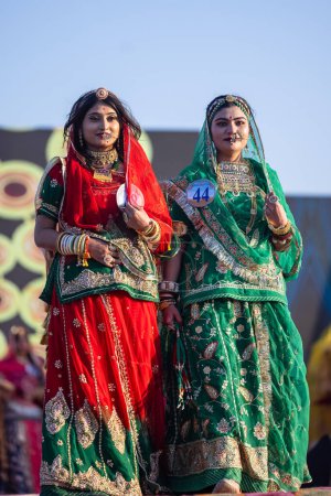 Photo for Bikaner, Rajasthan, India - January 14, 2023: Portrait of young beautiful indian women in ethnic rajasthani dresses participating in miss marwar fashion show during bikaner camel festival - Royalty Free Image