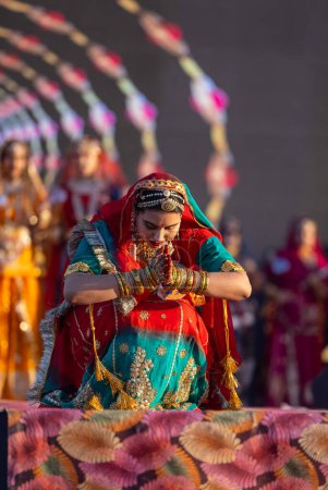 Photo for Bikaner, Rajasthan, India - January 14 2023: Portrait of young beautiful indian woman in ethnic rajasthani dress participating in miss marwar fashion show during bikaner camel festival - Royalty Free Image