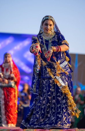 Photo for Bikaner, Rajasthan, India - January 14 2023: Portrait of young beautiful indian woman in ethnic rajasthani lehenga choli dress participating in miss marwar fashion show during bikaner camel festival - Royalty Free Image