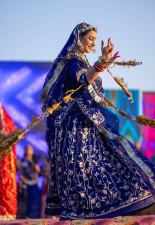 Photo for Bikaner, Rajasthan, India - January 14 2023: Portrait of young beautiful indian woman in ethnic rajasthani lehenga choli dress participating in miss marwar fashion show during bikaner camel festival - Royalty Free Image