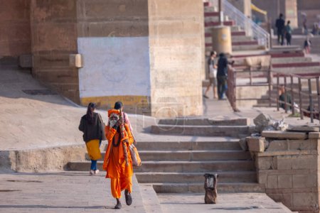 Photo for Varanasi, Uttar Pradesh, India - March 05, 2023: Portrait of holy sadhu baba in traditional dress walking on the ghats near ganges in varanasi - Royalty Free Image