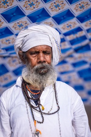 Photo for Varanasi, Uttar Pradesh, India - March 05 2023: Portrait of old holy sadhu baba in traditional dress on ghats near ganges in varanasi. Kashi is the oldest and holy city - Royalty Free Image