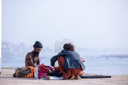 Photo for Varanasi, Uttar Pradesh, India - March 05 2023: Portrait of holy sadhu baba in traditional dress sitting on the ghats near ganges in varanasi. Kashi is the oldest and holy city. - Royalty Free Image