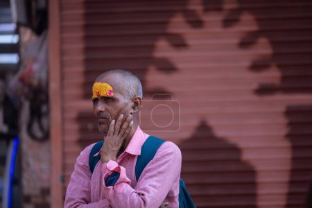 Photo for Varanasi, Uttar Pradesh, India - March 05 2023: Portrait of holy south indian brahmin male in traditional dress standing on the ghats near ganges in varanasi - Royalty Free Image