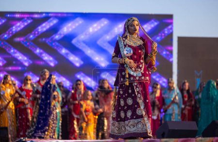 Photo for Bikaner, Rajasthan, India - January 14 2023: Portrait of young beautiful indian woman  in ethnic rajasthani lehenga choli dress participating in miss marwar fashion show during bikaner camel festival - Royalty Free Image