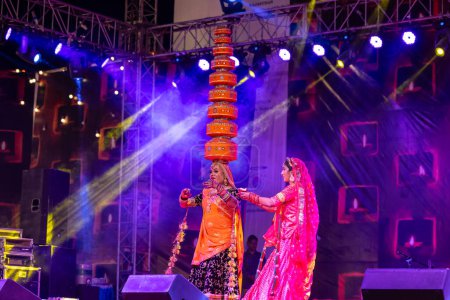 Photo for Pushkar, Rajasthan, India - November 06 2022: Artist performing rajasthani folk dance on stage at pushkar fair in colorful ethnic rajasthani dress and jewellery. - Royalty Free Image