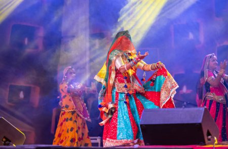 Photo for Pushkar, Rajasthan, India - November 06 2022: Beautiful female artists performing rajasthani folk dance on stage at pushkar fair in colorful ethnic rajasthani dresses and jewellery. - Royalty Free Image