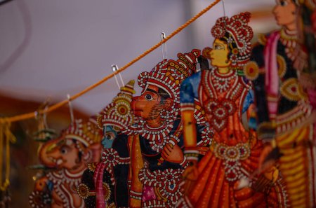 Handmade hindu god idol of paper with colours on display for sale.