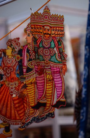 Handmade hindu god idol of paper with colours on display for sale.
